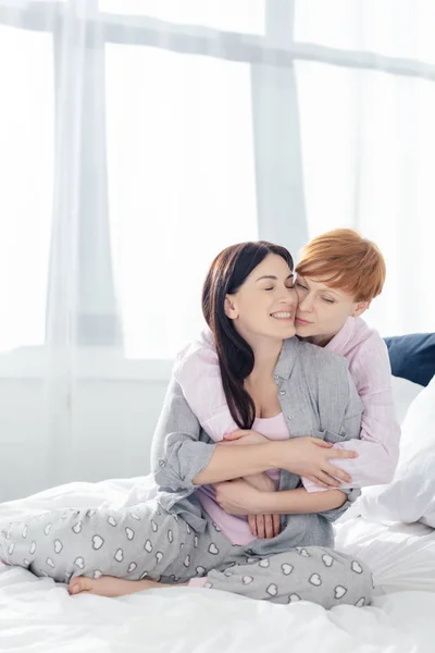 Woman Embracing Cheerful Girlfriend Bed Bedroom — Stock Photo, Image