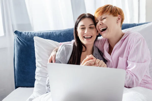 Same Sex Couple Laughing While Using Laptop Bed — Stock Photo, Image