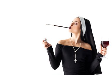attractive sexy nun with lighter and glass of wine smoking a cigarette in mouthpiece isolated on white clipart