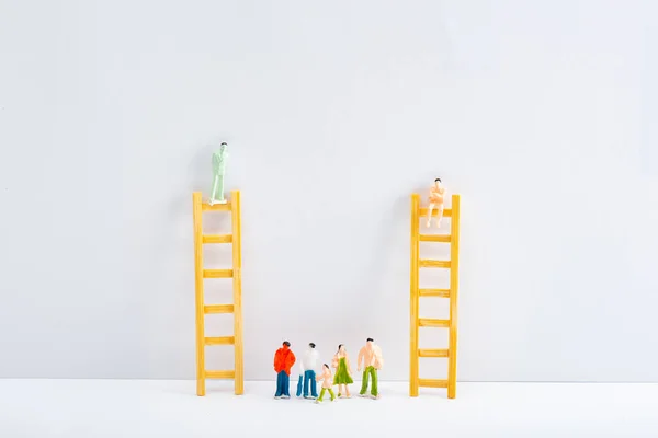 Dolls Ladders People Figures White Surface Grey Background Concept Equality — Stock Photo, Image