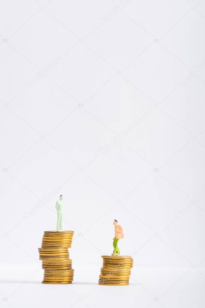 People figures on golden coins on white surface isolated on grey, concept of financial equality