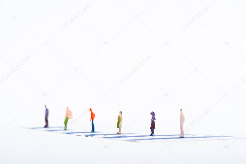 Selective focus of people figures on blue charts isolated on white, concept of equality