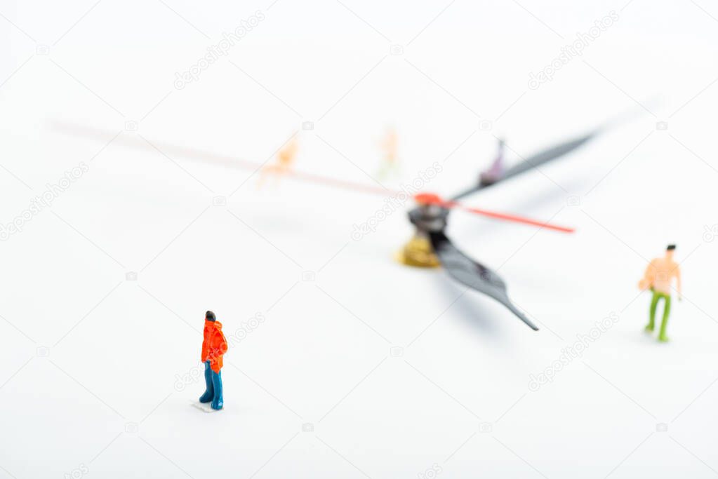 Selective focus of people figures and black and red arrows of watch on white background, concept of senescence
