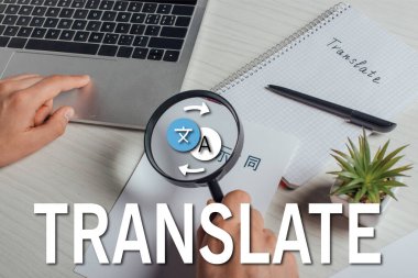 cropped view of translator working with hieroglyphics, laptop and magnifying glass, translate illustration clipart