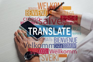 cropped view of translator writing in notepad with smartphone, welcome translation illustration clipart