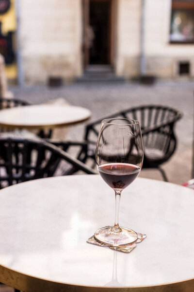 Selective focus of glass of wine on table 