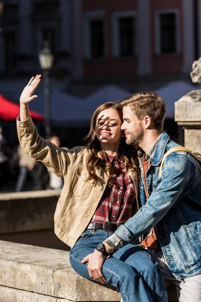 Happy Girlfriend Covering Face Hand Boyfriend Sitting Together Stone Smiling — Stock Photo, Image