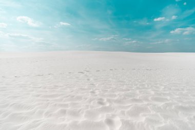 beautiful clean beach with white sand and blue sky with white clouds clipart