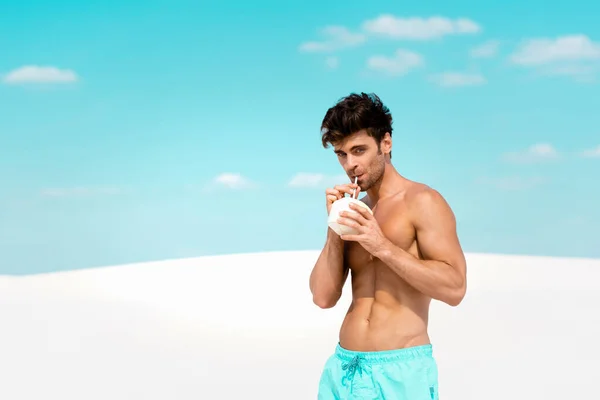 Sexy Man Muscular Torso Swim Shorts Coconut Drink Sandy Beach — Stock Photo, Image