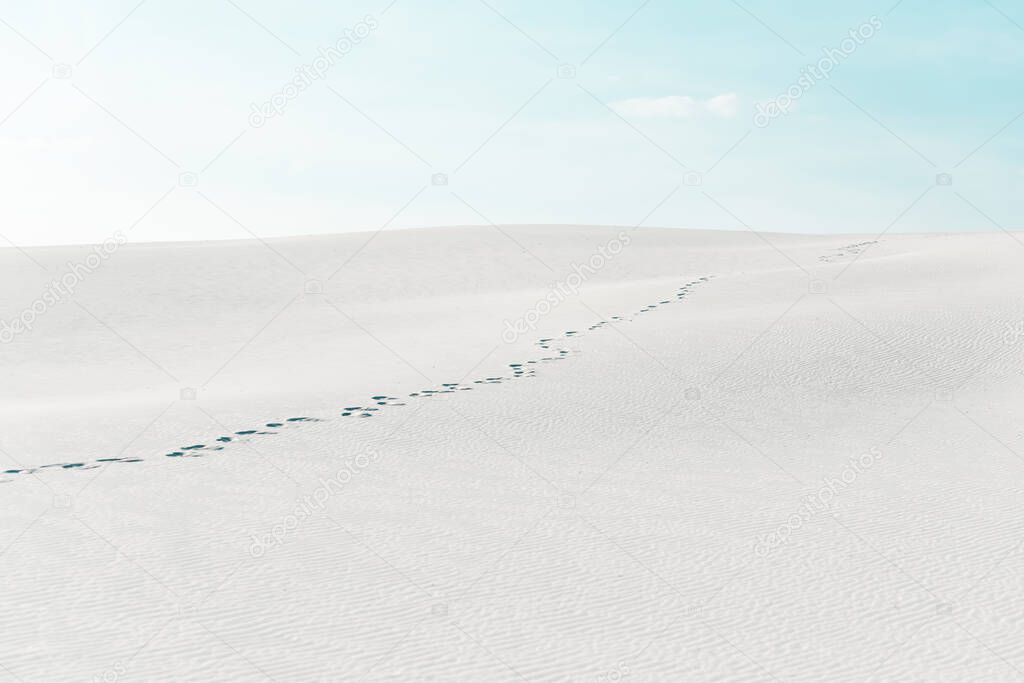 beautiful beach with traces on white sand and blue sky