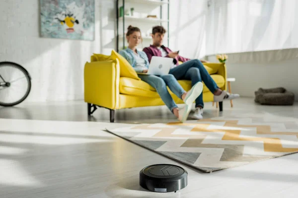 Selective Focus Robotic Vacuum Cleaner Washing Carpet Man Watching Movie — Stock Photo, Image