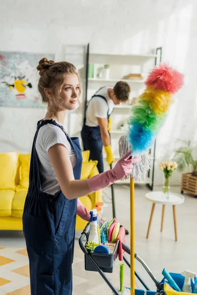 Selective Focus Attractive Cleaner Holding Duster Brush Cleaning Trolley — Stock Photo, Image