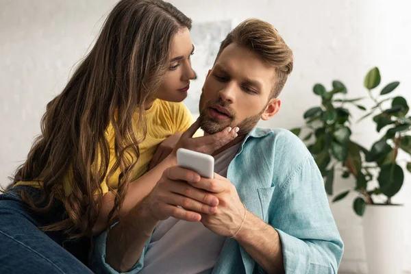 Çekici Kız Oturma Odasında Akıllı Telefonuyla Sevgilisine Dokunuyor — Stok fotoğraf