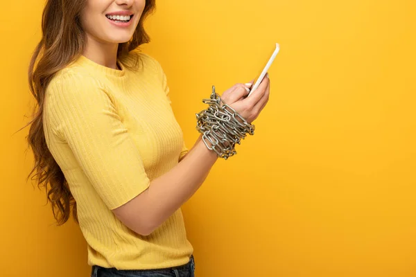 Cropped View Smiling Woman Holding Smartphone Tied Hands Chain Yellow — Stock Photo, Image