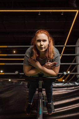 low angle view of focused overweight girl doing lower back extension exercise on training machine clipart