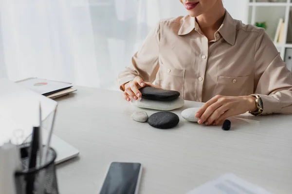 Cropped View Businesswoman Sitting Workplace Zen Stones Smartphone Laptop — Stock Photo, Image