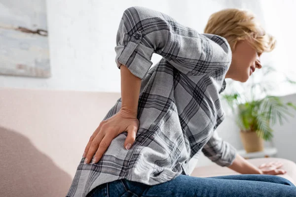 Selective Focus Mature Woman Suffering Back Pain While Sitting Sofa — Stock Photo, Image