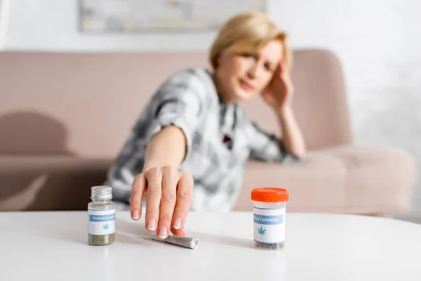 Selective Focus Mature Woman Taking Rolled Joint Legal Marijuana Bottles — Stock Photo, Image