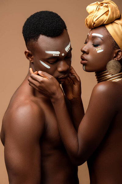 sexy naked tribal afro couple posing isolated on beige