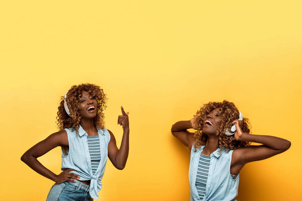 коллаж счастливой африканской женщины, слушающей музыку в наушниках на желтом фоне
