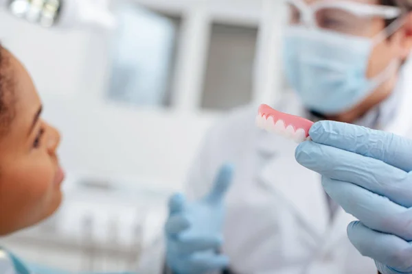 Selective Focus Dentist Latex Gloves Holding Dental Prosthesis African American — Stock Photo, Image