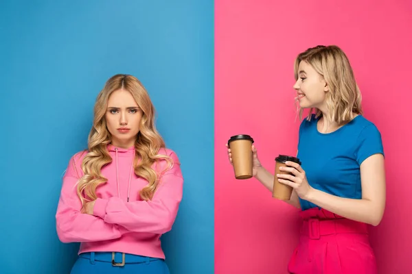 Smiling Blonde Girl Paper Cups Looking Offended Sister Pink Blue — Stock Photo, Image