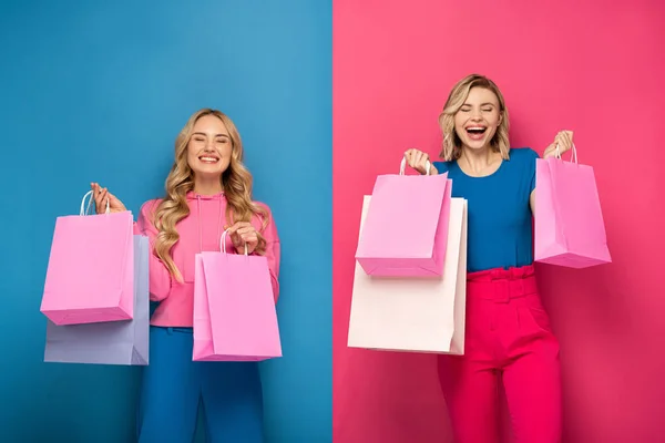 Happy Blonde Zussen Met Gesloten Ogen Houden Boodschappentassen Roze Blauwe — Stockfoto