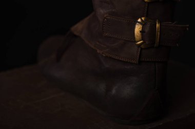 close up view of medieval Scottish brown leather shoes with buckle clipart