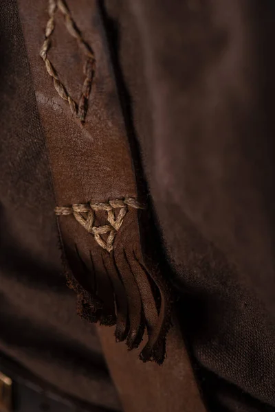 close up view of medieval Scottish brown leather clothing