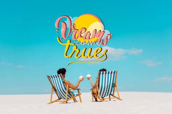 back view of young couple sitting in deck chairs with coconut drinks on sandy beach, dreams come true illustration
