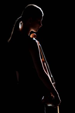silhouette of female musician holding violin isolated on black clipart