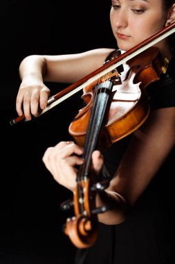 attractive professional musician playing symphony on violin isolated on black clipart