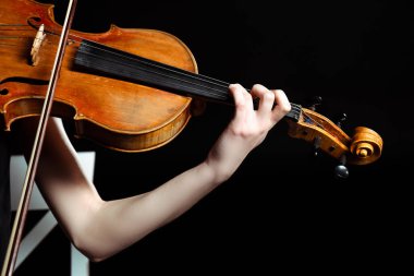 cropped view of female musician playing on violin isolated on black clipart