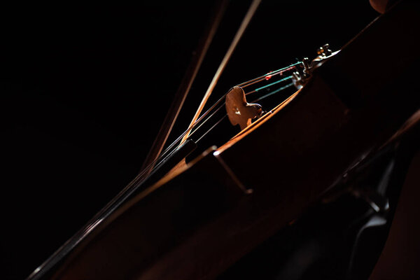 partial view of musician playing symphony on violin isolated on black
