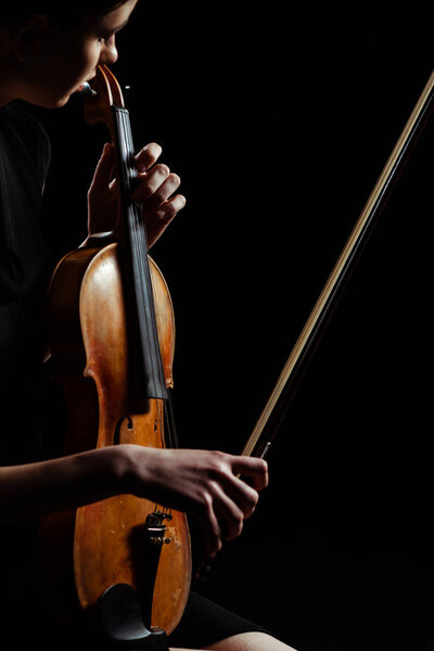 attractive musician playing symphony on violin isolated on black