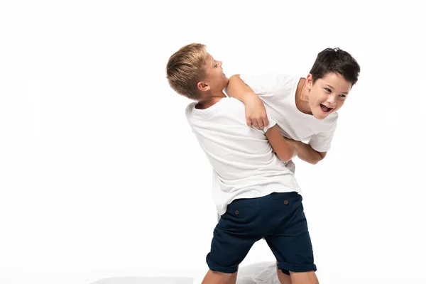 Two brothers having fun while imitating fighting isolated on white — Stock Photo