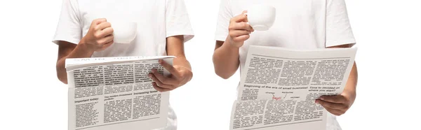 Partial view of two kids reading newspapers while holding cups of coffee isolated on white, panoramic shot — Stock Photo