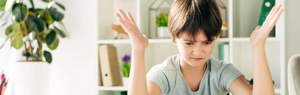 Panoramic shot of irritated kid with dyslexia looking down — Stock Photo