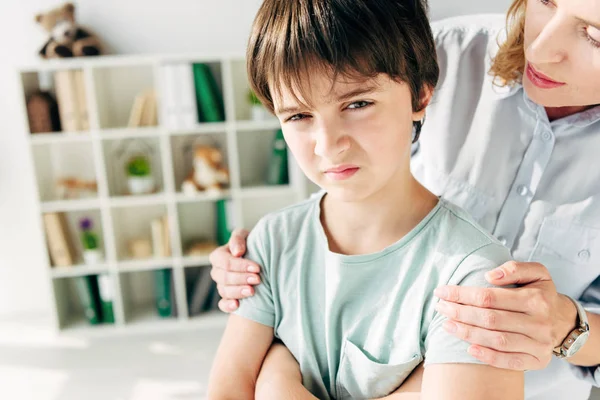 Abgeschnittene Ansicht eines Kinderpsychologen, der Kind mit Legasthenie umarmt — Stockfoto