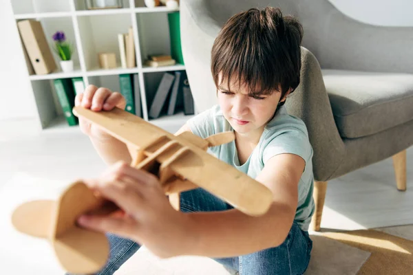 Enfoque selectivo del niño con dislexia jugando con el plano de madera - foto de stock