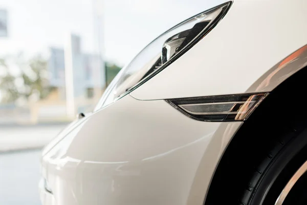 KYIV, UKRAINE - OCTOBER 7, 2019: close up of headlight of luxury white porshe outside — Stock Photo