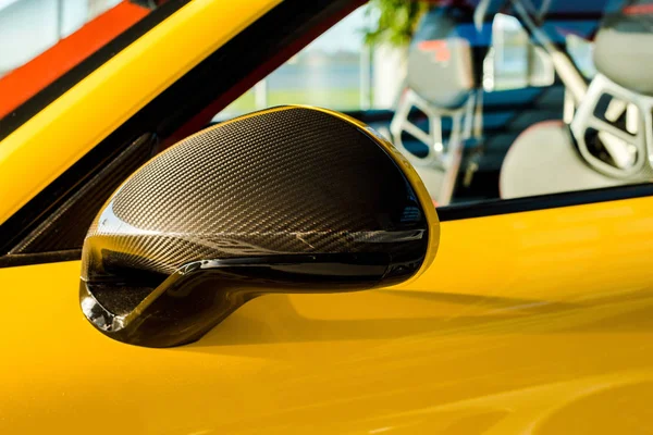 KYIV, UKRAINE - OCTOBER 7, 2019: selective focus of sunshine on car mirror of luxury porshe — Stock Photo