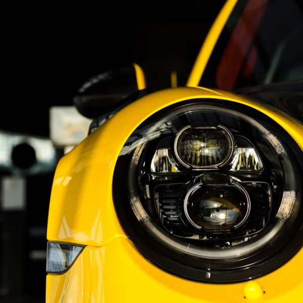 KYIV, UKRAINE - OCTOBER 7, 2019: close up of modern headlight in yellow porshe — Stock Photo