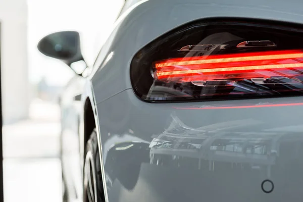 KYIV, UKRAINE - OCTOBER 7, 2019: selective focus of red headlight of white porshe — Stock Photo