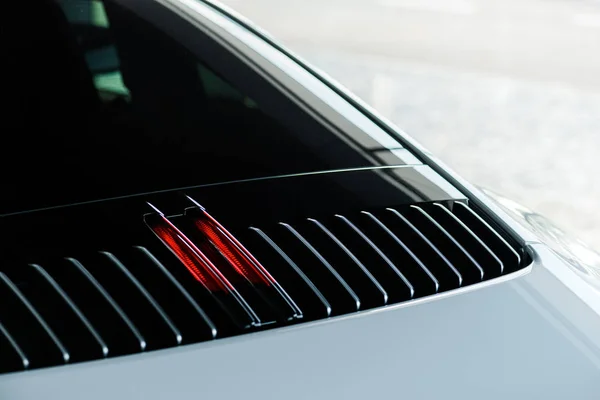 KYIV, UKRAINE - OCTOBER 7, 2019: selective focus of red car stop light in white porshe — Stock Photo