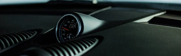 KYIV, UKRAINE - OCTOBER 7, 2019: panoramic shot of black speedometer in luxury porshe — Stock Photo