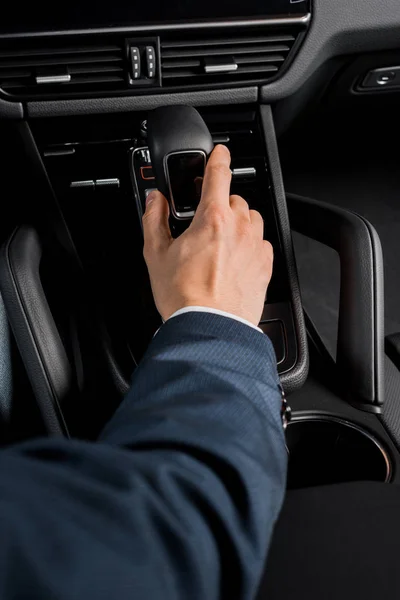 KYIV, UKRAINE - OCTOBER 7, 2019: selective focus of driver touching gearbox in modern porshe — Stock Photo