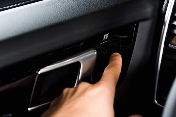 KYIV, UKRAINE - OCTOBER 7, 2019: cropped view of man touching car handle while opening door in porshe — Stock Photo