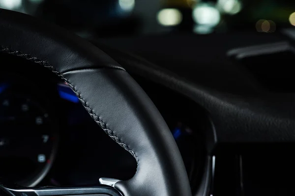 KYIV, UKRAINE - OCTOBER 7, 2019: close up of black leather steering wheel in new porshe — Stock Photo