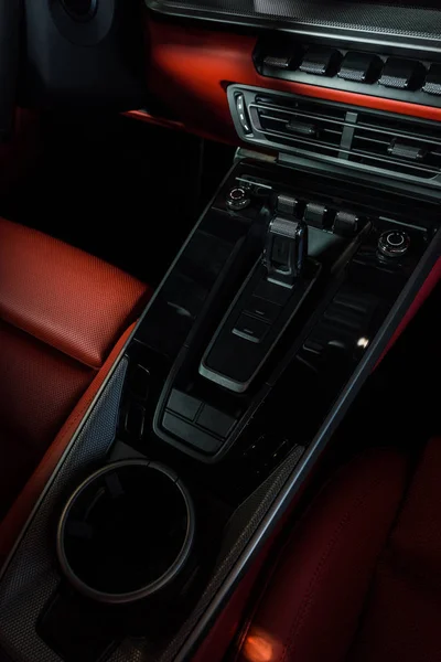 KYIV, UKRAINE - OCTOBER 7, 2019: black buttons near air conditioner and cup holder in modern porshe — Stock Photo